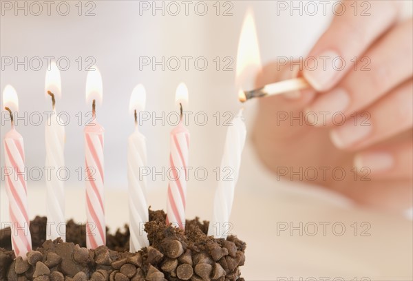 Woman lighting birthday candles. Date : 2007
