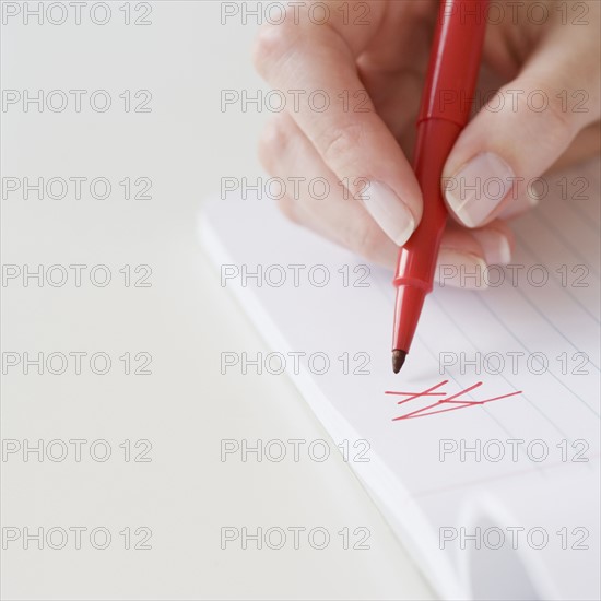 Teacher writing A plus on paper. Date : 2007