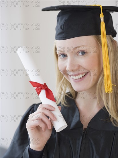 Woman wearing graduation cap and gown. Date : 2007