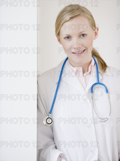 Female doctor leaning on wall. Date : 2007