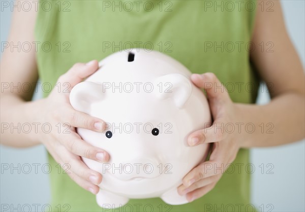 Boy holding piggy bank. Date : 2007