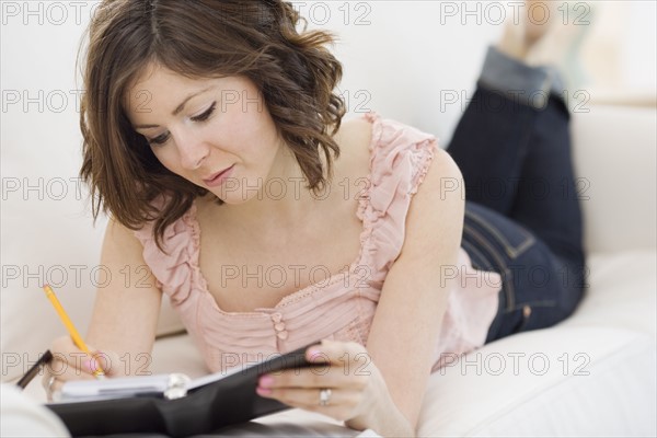 Woman writing in date book. Date : 2007