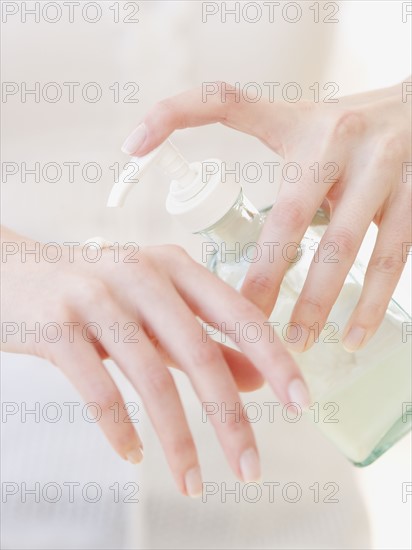 Woman applying hand lotion. Date : 2007