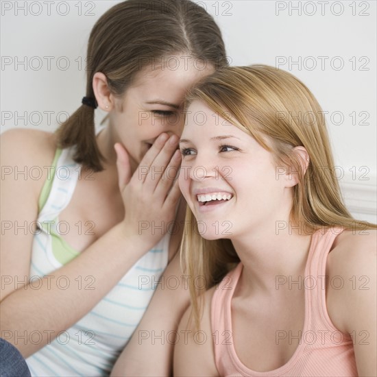 Teenage girl telling secret. Date : 2007
