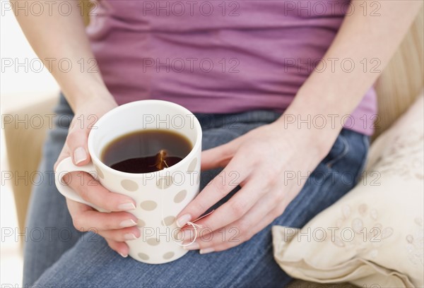 Woman holding tea cup. Date : 2007