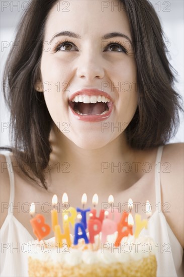 Woman laughing next to birthday cake. Date : 2007