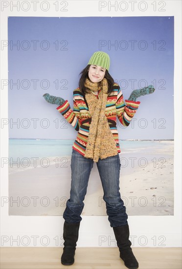 Woman in winter clothing in front of beach picture. Date : 2007