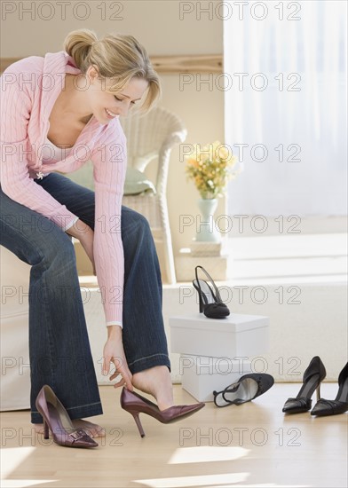 Woman trying on shoes in shop. Date : 2007