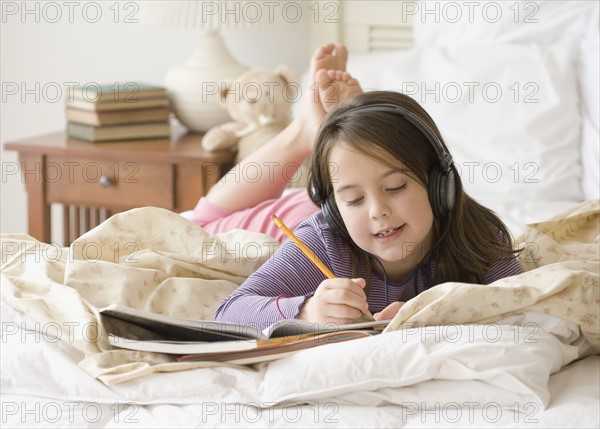 Girl listening to headphones and studying. Date : 2006