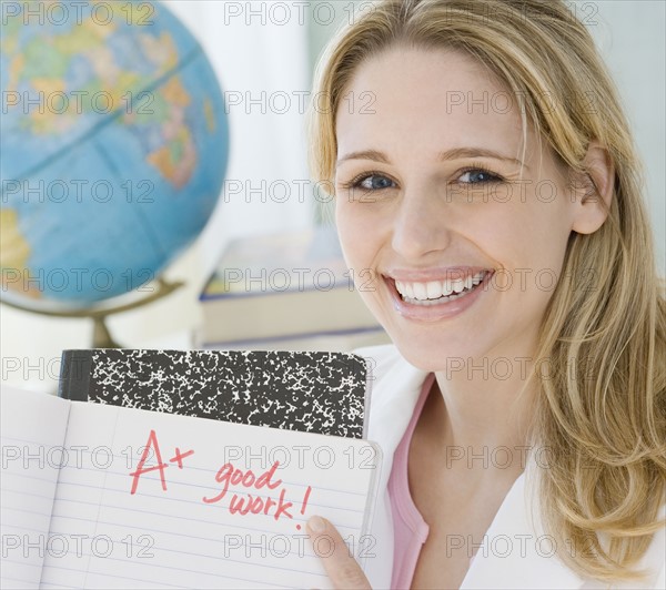 Female teacher holding A plus paper. Date : 2007