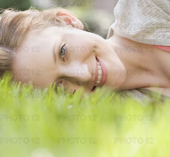 Portrait of woman laying in grass. Date : 2006