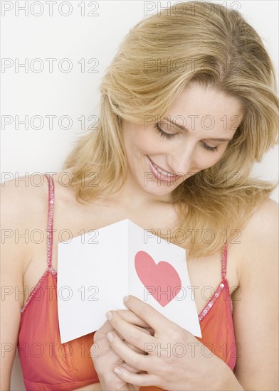 Woman holding card with heart. Date : 2007