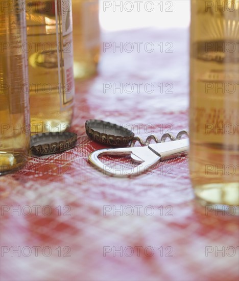 Close up of beer bottles and bottle opener. Date : 2006