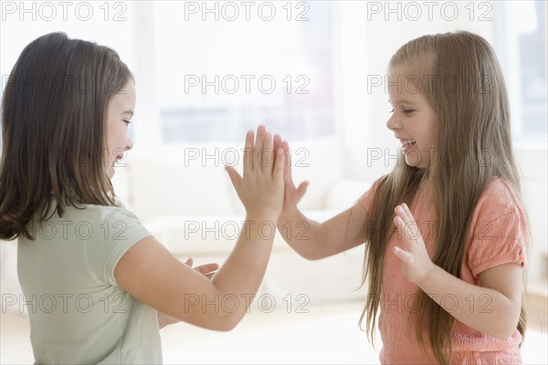 Sisters playing paddy cake. Date : 2006