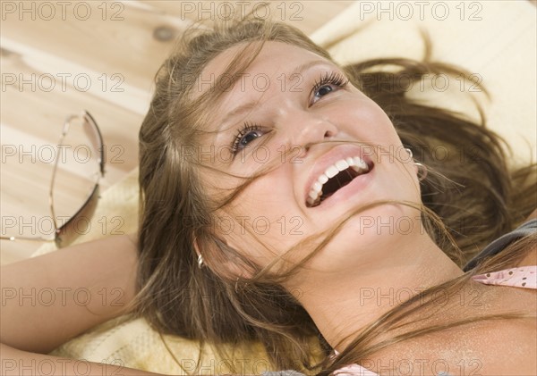 Close up of young woman laying on floor smiling. Date : 2006