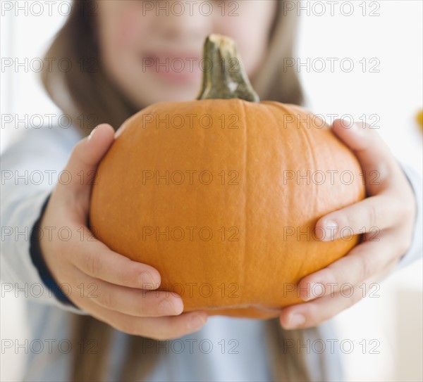 Close up of girl holding pumpkin. Date : 2006