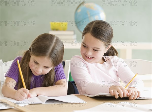 Two girls studying in classroom. Date : 2006