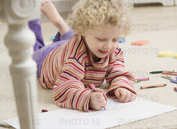 Child drawing with crayon. Date : 2006
