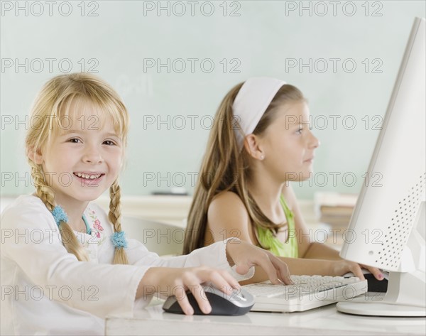 Two young girls using computers. Date : 2006