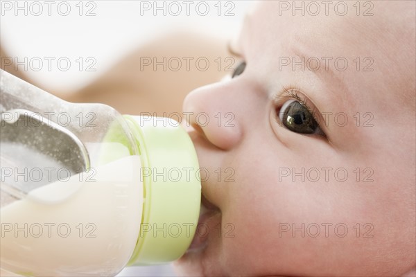 Close up of baby drinking from bottle. Date : 2006