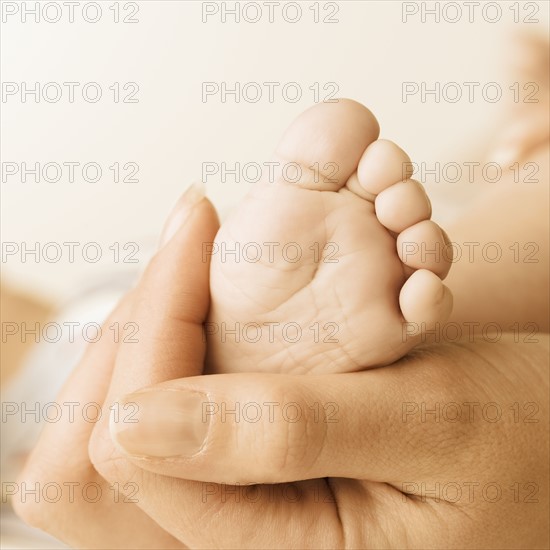 Close up of baby’s foot in mother’s hand. Date : 2006