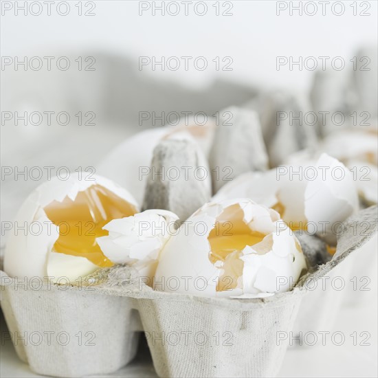 Close up of broken eggs in carton. Date : 2006