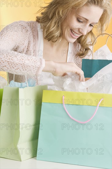 Woman looking in shopping bags. Date : 2006