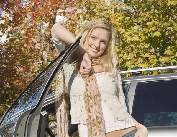 Woman posing with her car. Date : 2006