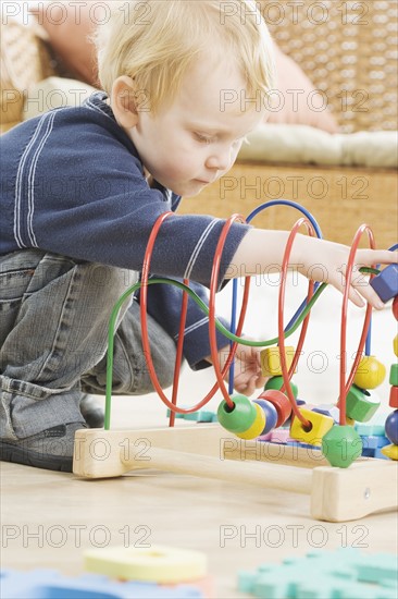 Young boy playing with block toy. Date : 2006