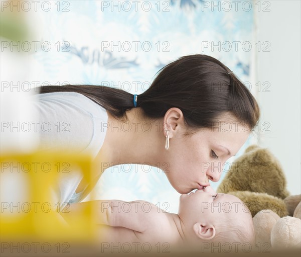 Mother kissing baby on nose. Date : 2006