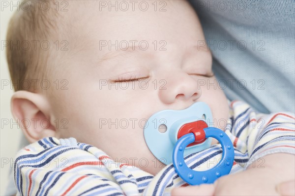 Close up of sleeping baby with pacifier. Date : 2006