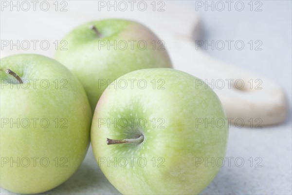 Green apples with cutting board. Date : 2006