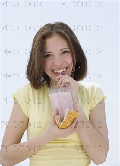 Woman drinking milkshake with straw. Date : 2007