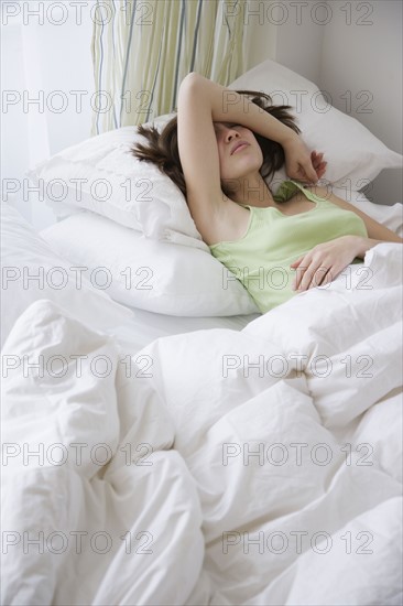 Woman laying in bed. Date : 2007