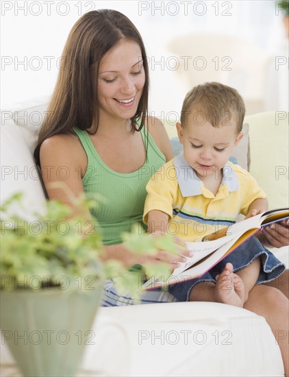 Mother reading to baby. Date : 2007