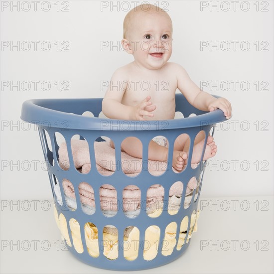 Baby sitting in laundry basket. Date : 2007