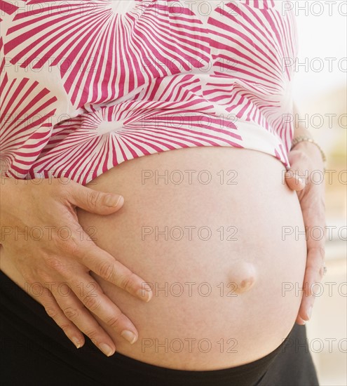 Pregnant woman with hands on belly. Date : 2007