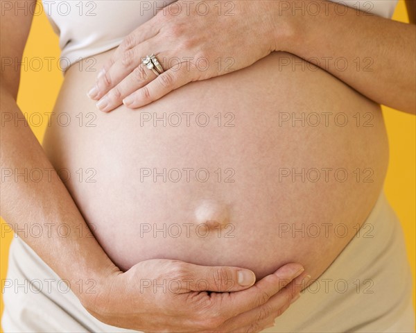 Pregnant woman with hands on belly. Date : 2007