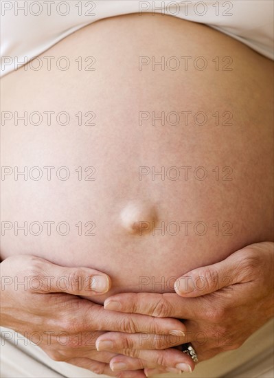 Pregnant woman with hands on belly. Date : 2007