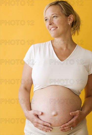 Pregnant woman with hands on belly. Date : 2007