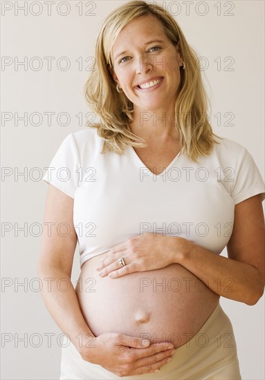 Pregnant woman with hands on belly. Date : 2007