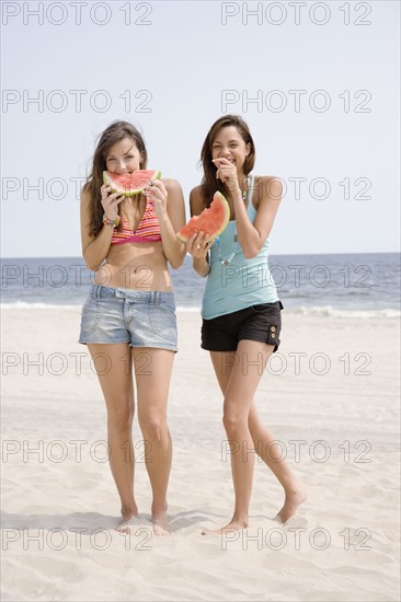 Women eating watermelon at beach. Date : 2007