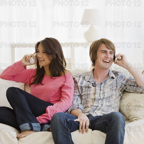 Couple talking on telephones. Date : 2007