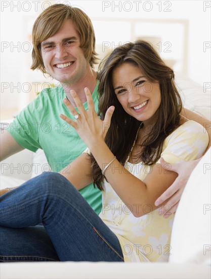 Engaged couple showing off engagement ring. Date : 2007