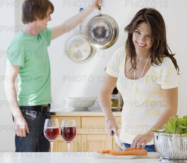 Couple preparing food in kitchen. Date : 2007