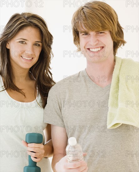 Couple holding water bottle and weight. Date : 2007