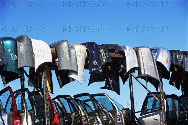 Car doors and bumpers at junkyard. Date : 2007