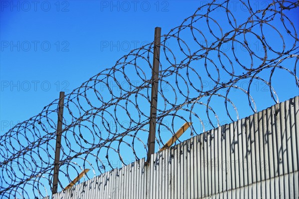 Low angle view of barbed wire fence. Date : 2007