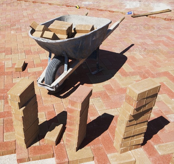 Wheelbarrow and bricks on new patio. Date : 2007