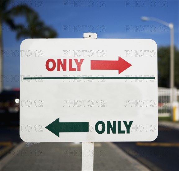 Street sign with arrows in opposite directions. Date : 2007